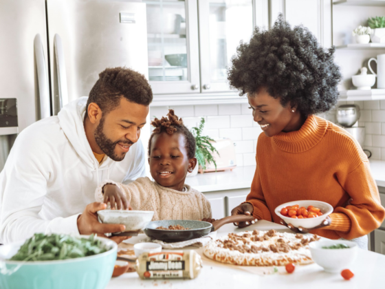 Family cooking together in a kitchen.