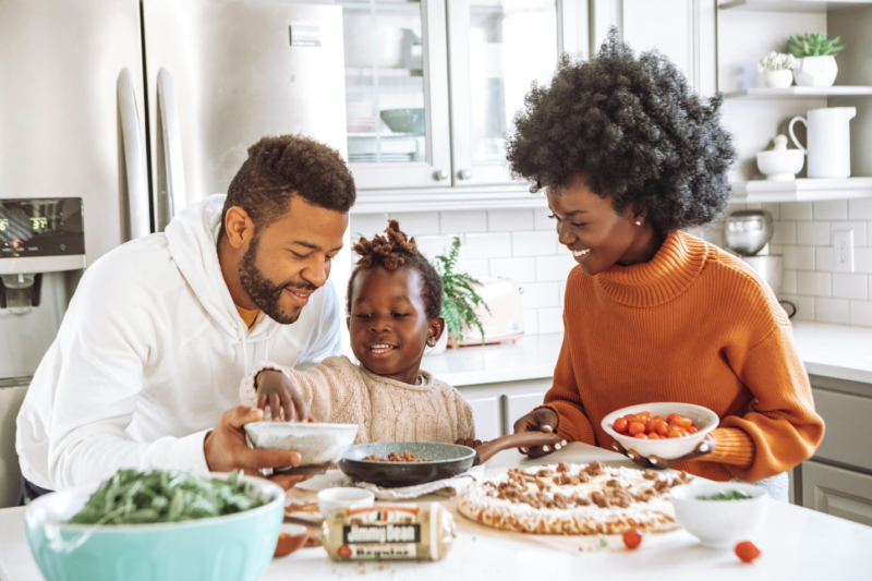 Family cooking together in a kitchen.