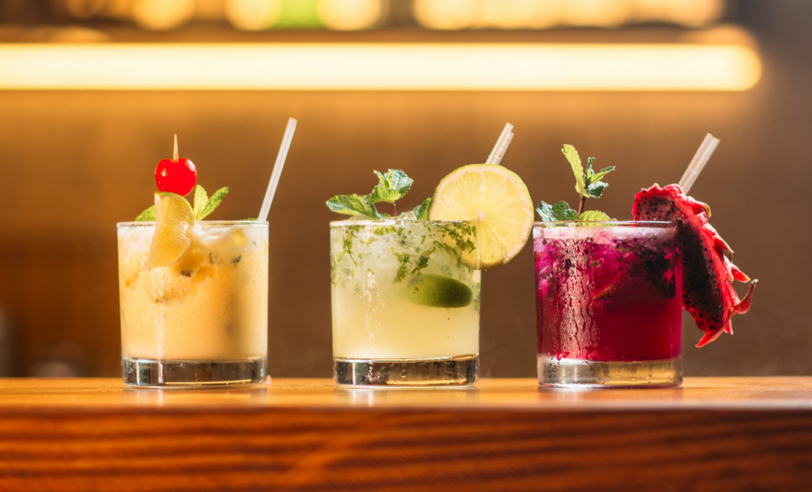  A variety of colorful tropical cocktails lined up on a bar in Barbados.