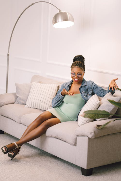 A woman lounging confidently in a trendy, well-designed small space. 