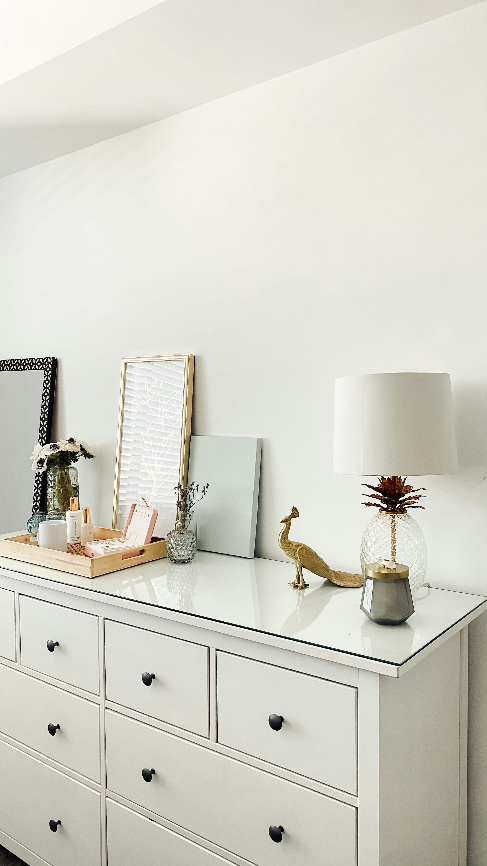 Elegant white dresser with gold and glass home accessories