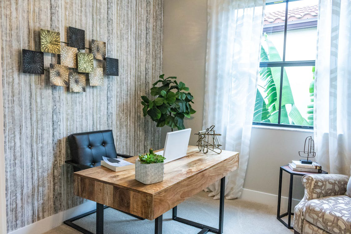 Earth-toned home office with natural light and lush greenery