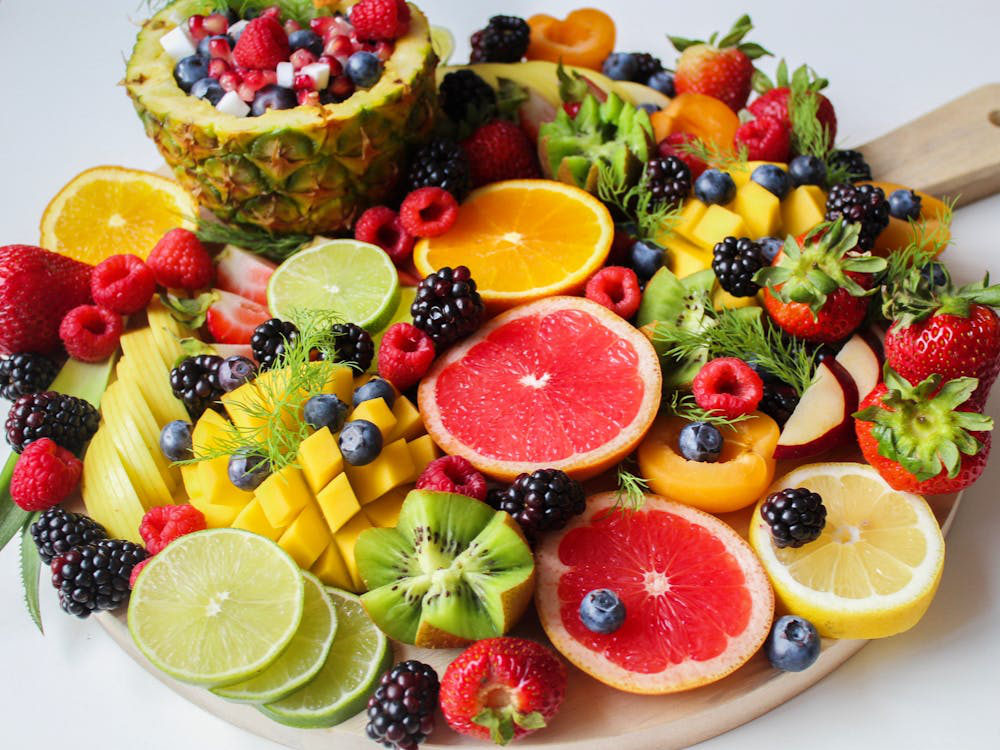 Colorful tropical fruit platter with watermelon, mango, kiwi, and berries